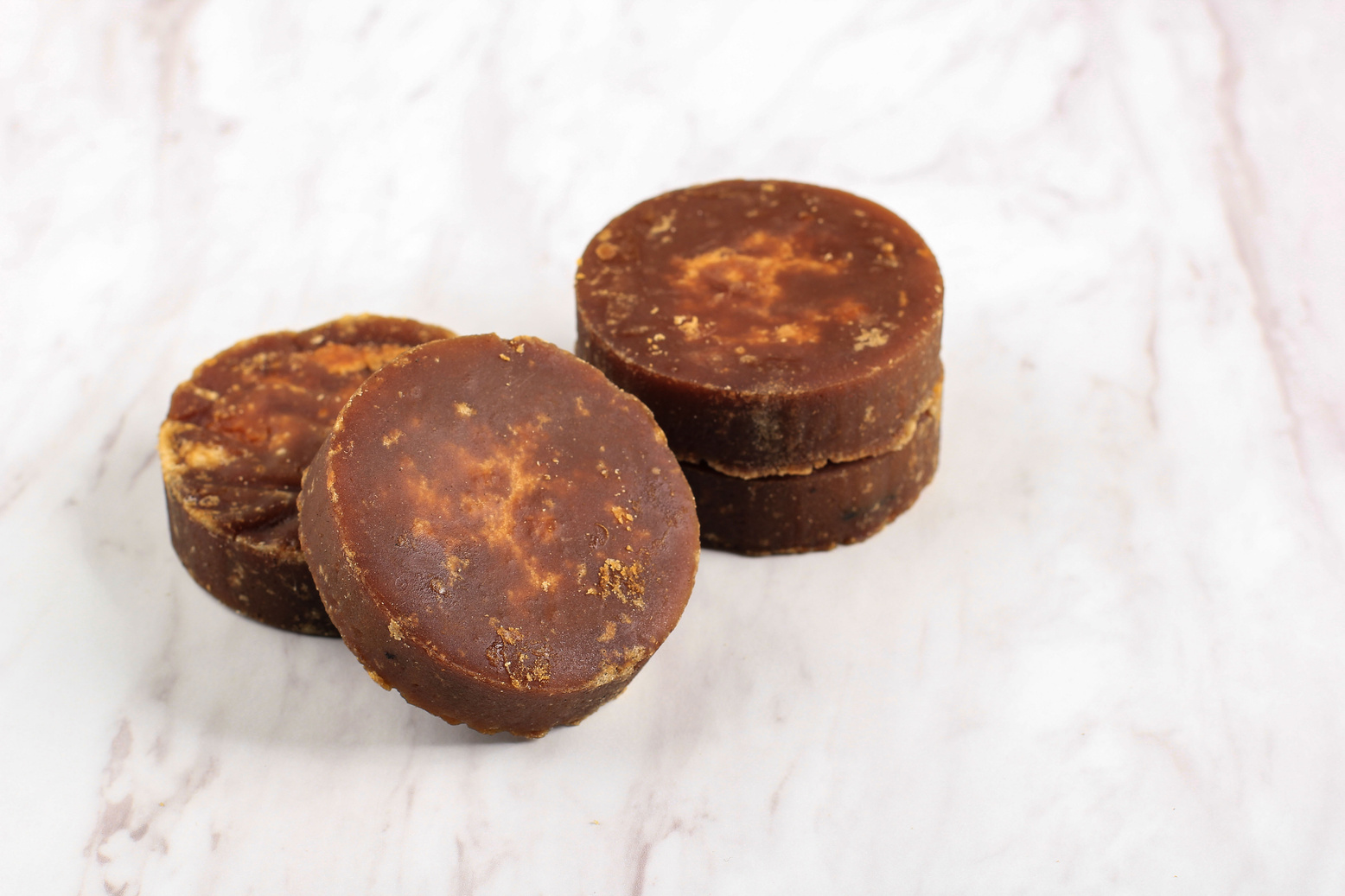 Gula Malacca or Coconut Palm Sugar, Popular as Brown Sugar (Gula Merah) with Coconut Milk and Pandan Leaf, Ingredients Aromatic Making Indonesian or Malaysian Traditional Cake. Isolated on White Marble Background